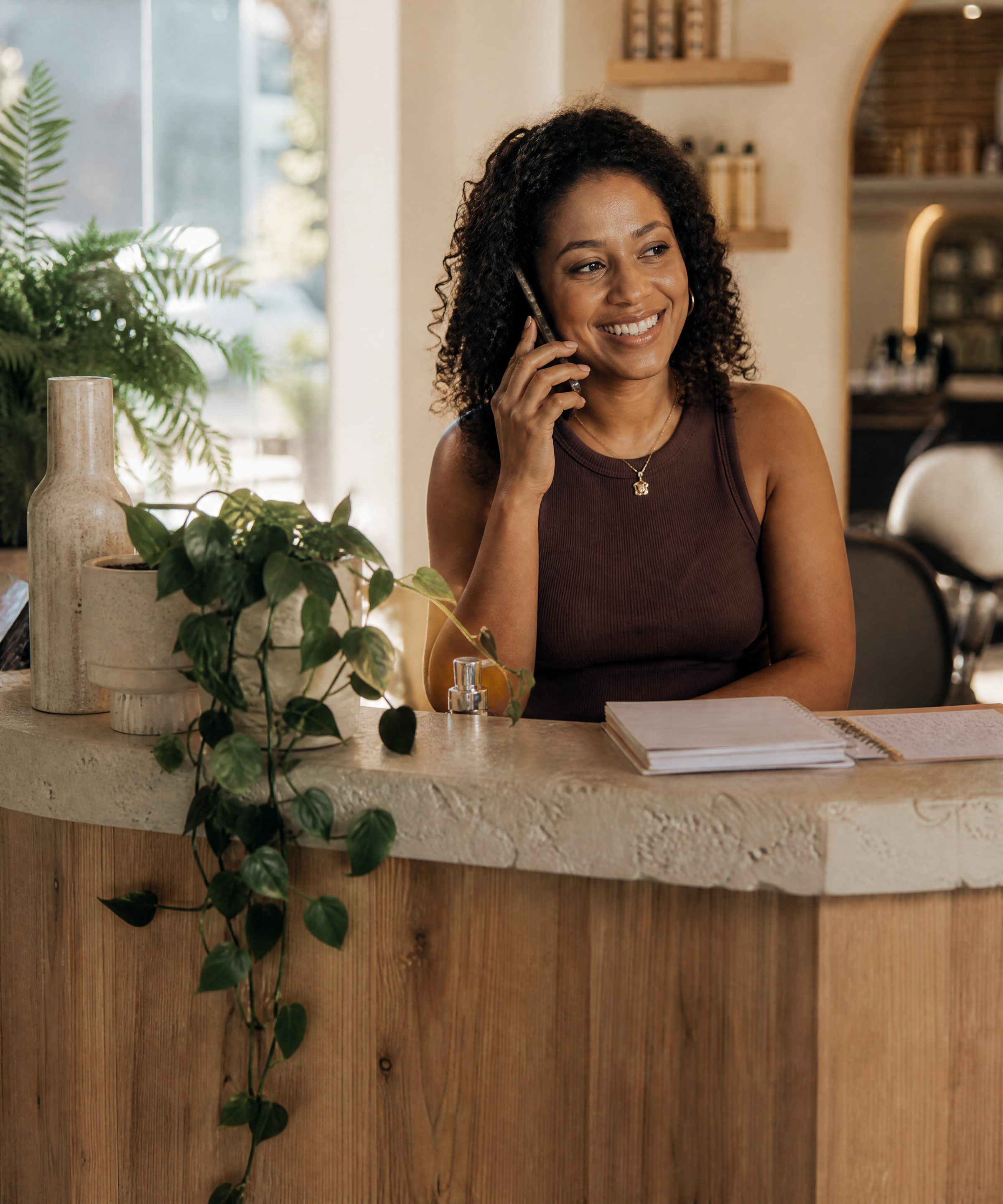 Lily answering calls at a salon reception desk